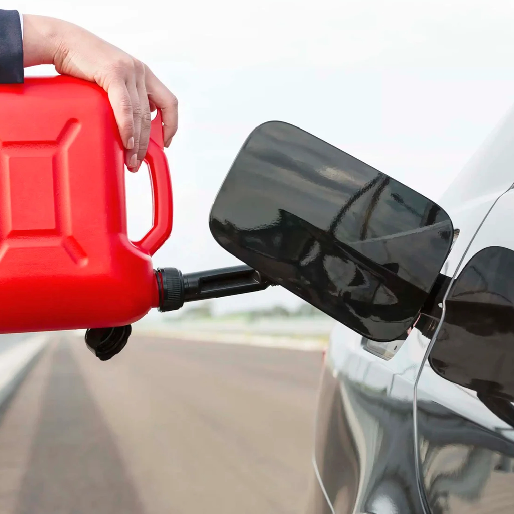 photo shows Big Wheel Wrecker Service tech putting fuel in a vehicle 