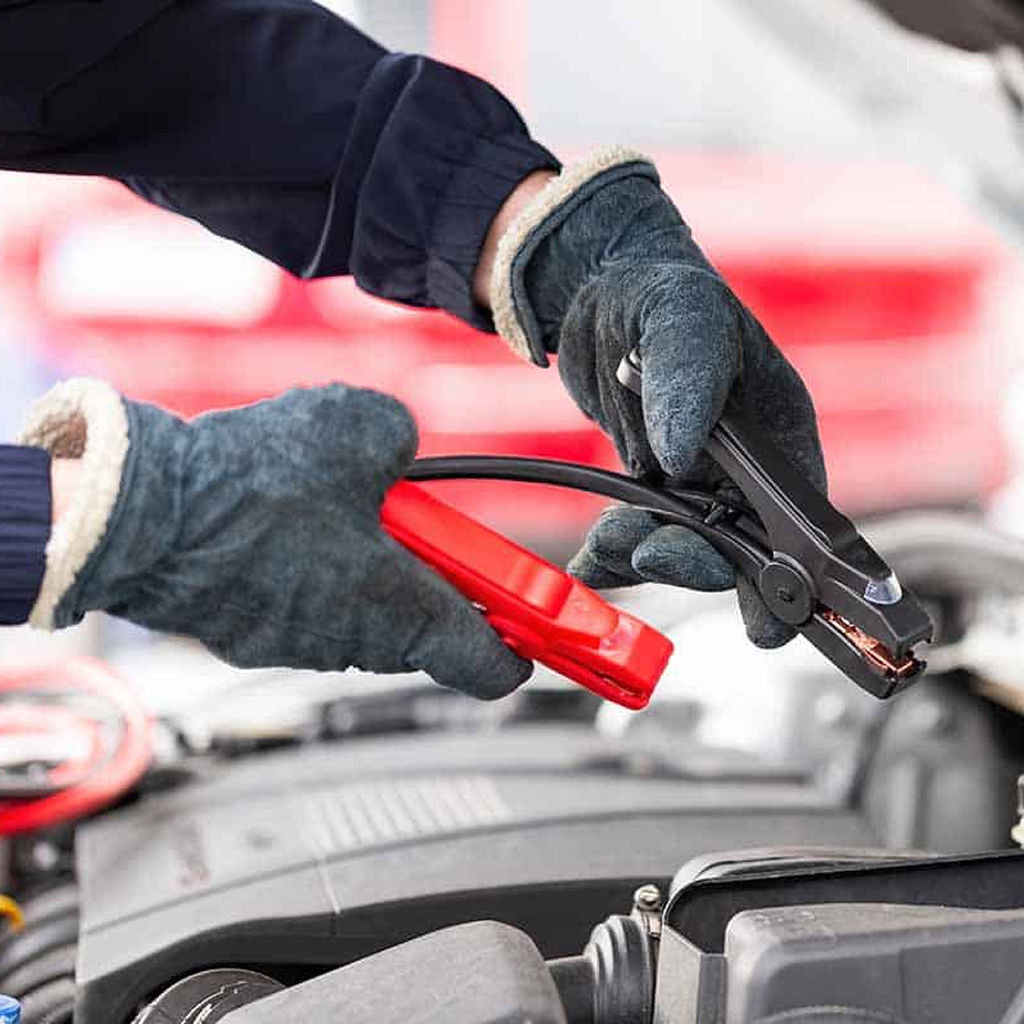 photo shows Big Wheel Wrecker Service tech putting jumpstarting a vehicle 